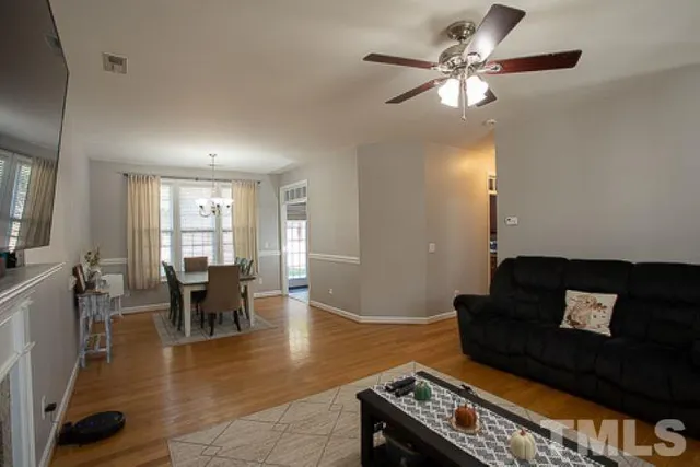 a living room with furniture and wooden floor