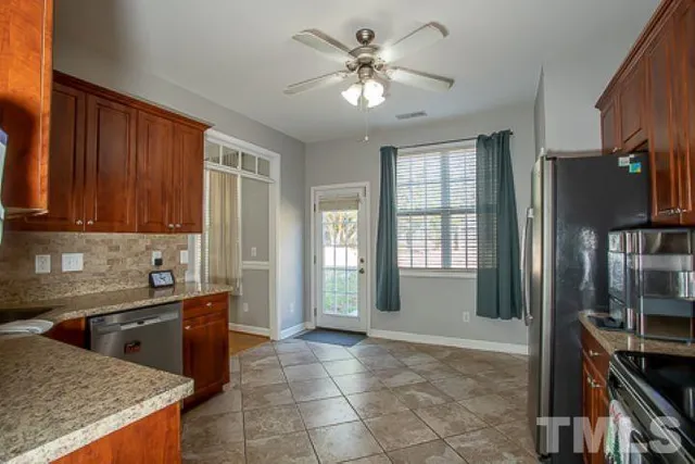 a view of a kitchen with a sink and cabinets