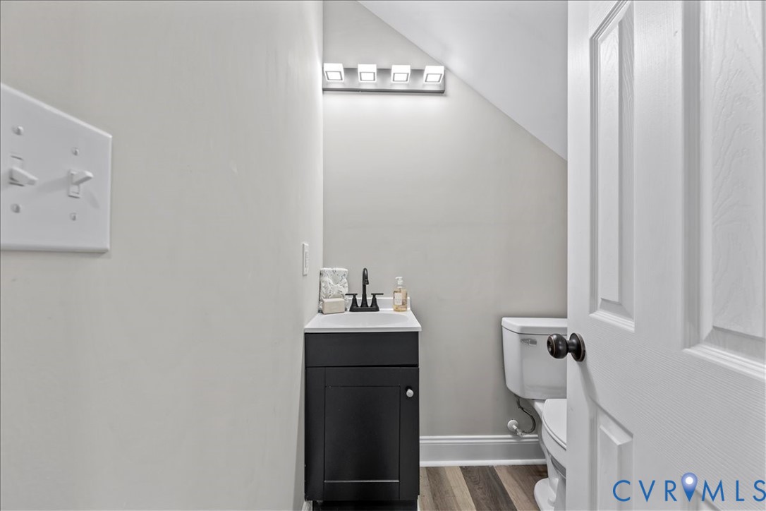 1348 Rome Street Petersburg, VA 23803 - Photo 20 of 45 Half bathroom featuring vanity, dark wood-style fl