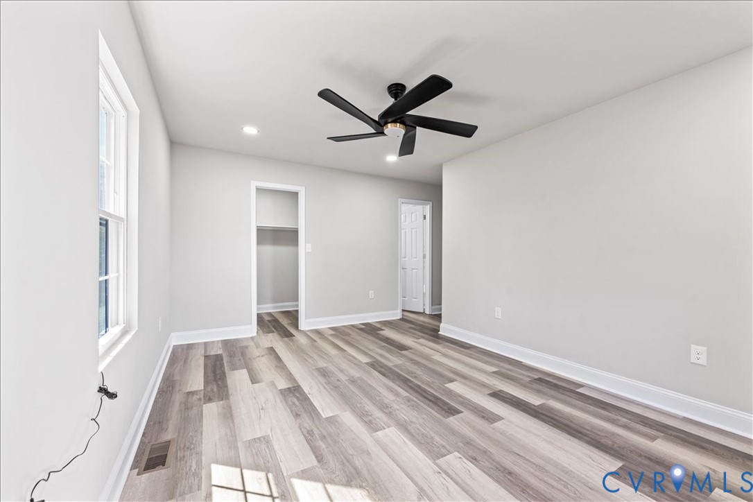 1348 Rome Street Petersburg, VA 23803 - Photo 31 of 45 Unfurnished bedroom featuring a walk in closet, li