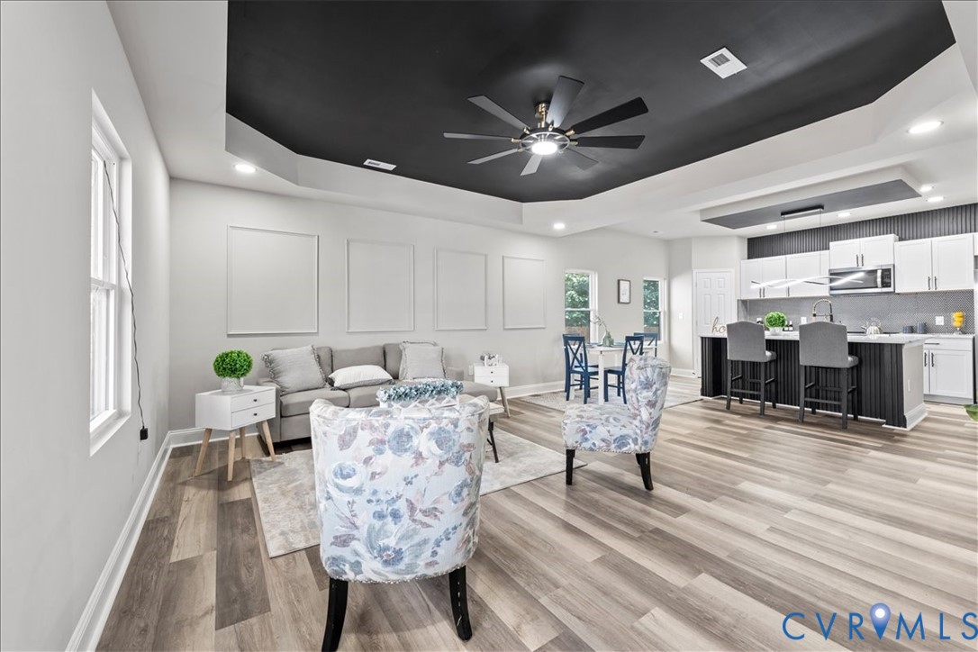 1348 Rome Street Petersburg, VA 23803 - Photo 10 of 45 Living room with a tray ceiling, light wood-type f