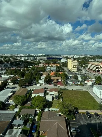 an aerial view of residential houses with city view