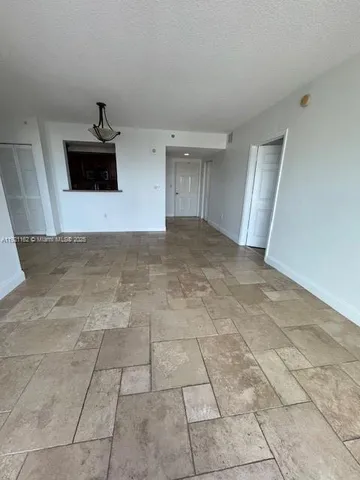 a view of a livingroom with an empty space and a sink