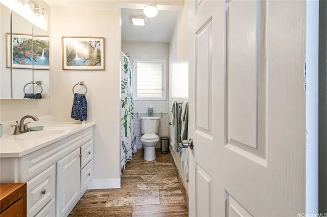 a spacious bathroom with a sink a mirror a vanity and window