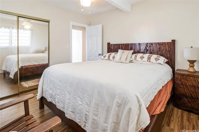 a large bed sitting in a bedroom next to a window