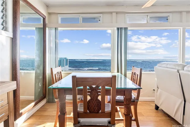 a view of a dining room with furniture wooden floor and a floor to ceiling window
