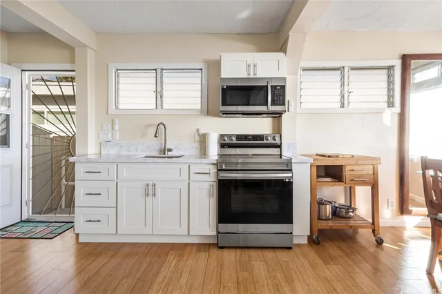 a kitchen with stainless steel appliances a stove microwave and cabinets