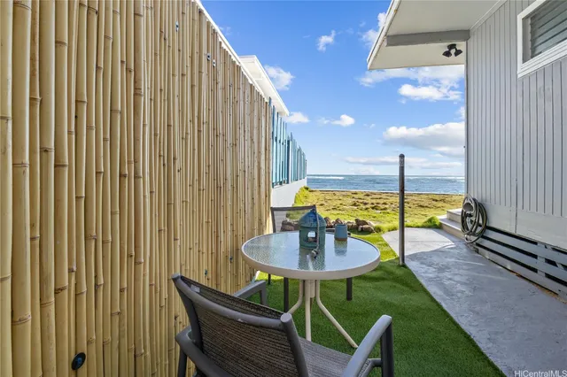 a view of a balcony with a table and chairs