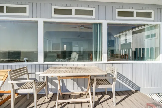 a view of a patio with table and chairs