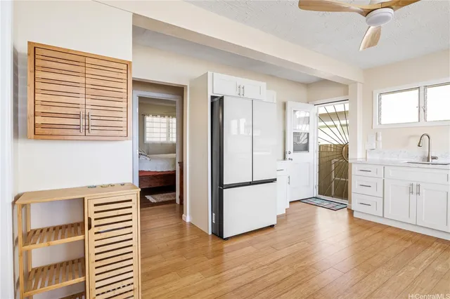 a kitchen with a refrigerator and a stove top oven