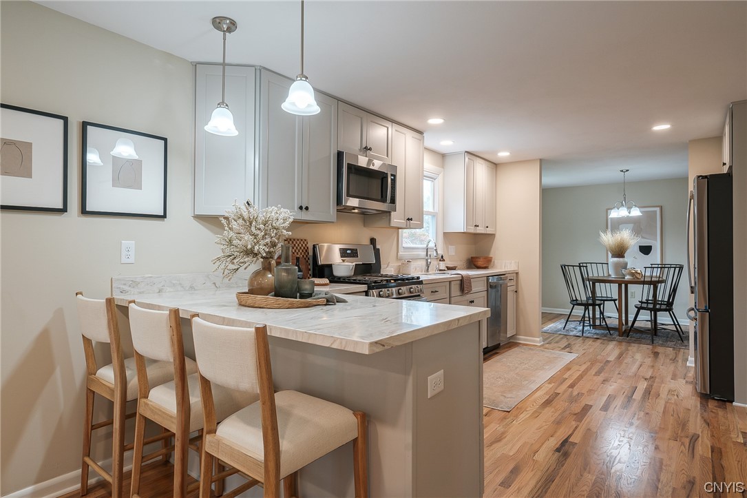 2268 Connell Terrace Lysander, NY 13027 - Photo 14 of 42 KITCHEN BREAKFAST BAR...NOTICE THE NICE COLORS IN