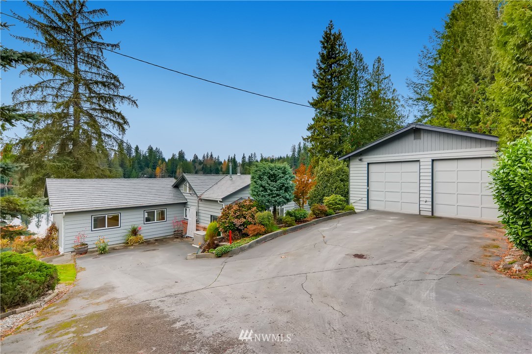 8716 East Lake Cochran Road Monroe, WA 98272 - Photo 1 of 29 a view of a house with a yard and potted plants