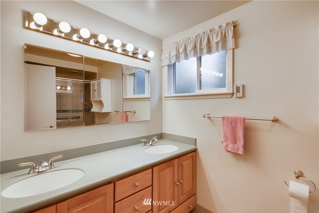 8716 East Lake Cochran Road Monroe, WA 98272 - Photo 11 of 29 a bathroom with a sink double vanity and a mirror