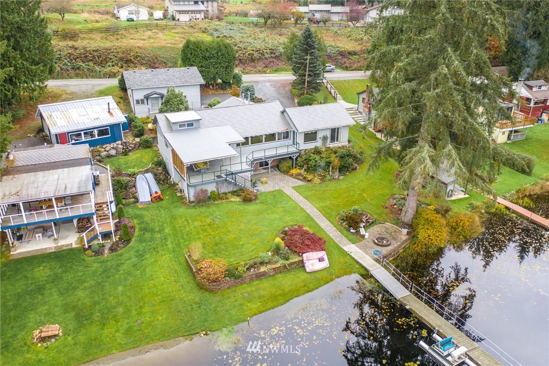 8716 East Lake Cochran Road Monroe, WA 98272 - Photo 28 of 29 an aerial view of a house with a garden and lake view