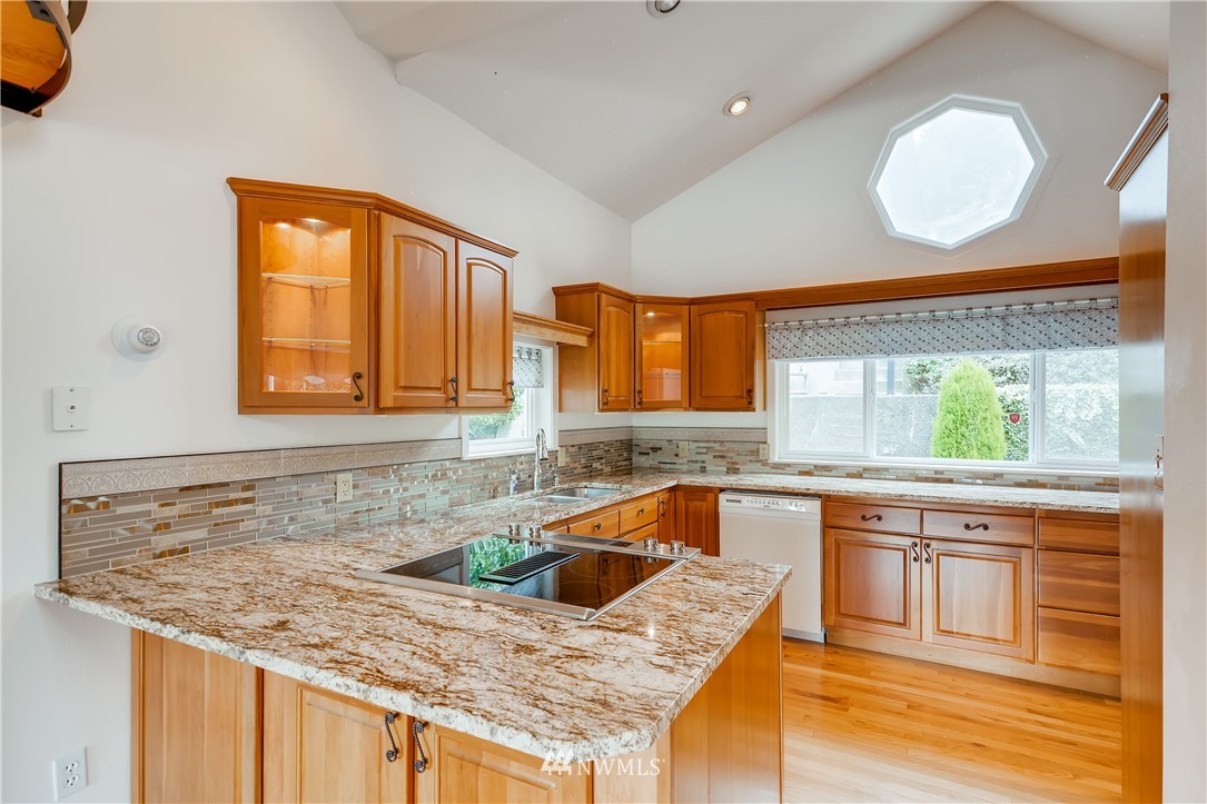 8716 East Lake Cochran Road Monroe, WA 98272 - Photo 7 of 29 a kitchen with a stove a sink and a wooden cabinets