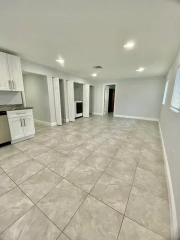 a view of a kitchen with a sink and a stove top oven