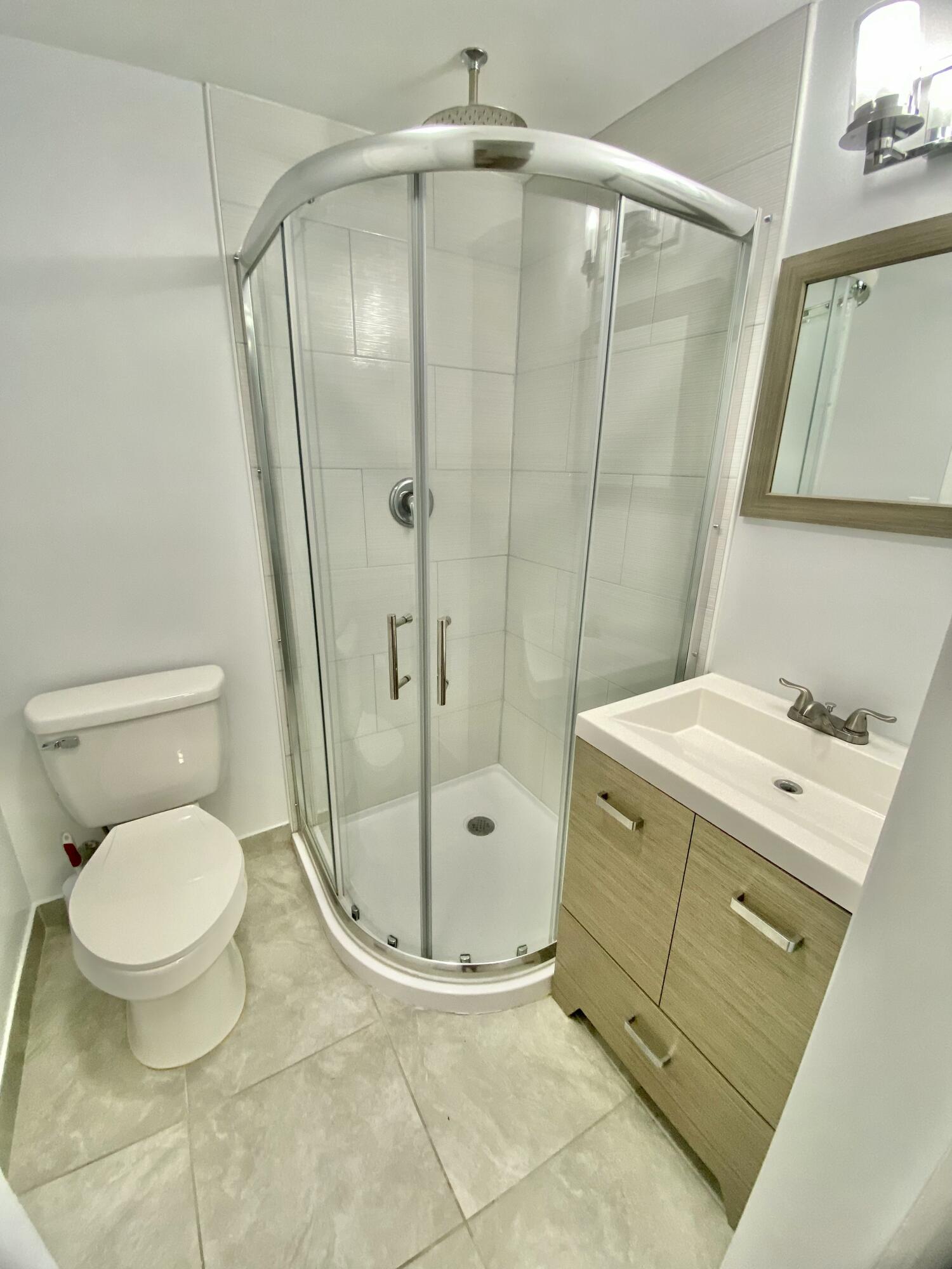 4344 Mars Avenue West Palm Beach, FL 33406 - Photo 5 of 11 a bathroom with a granite countertop sink toilet and shower
