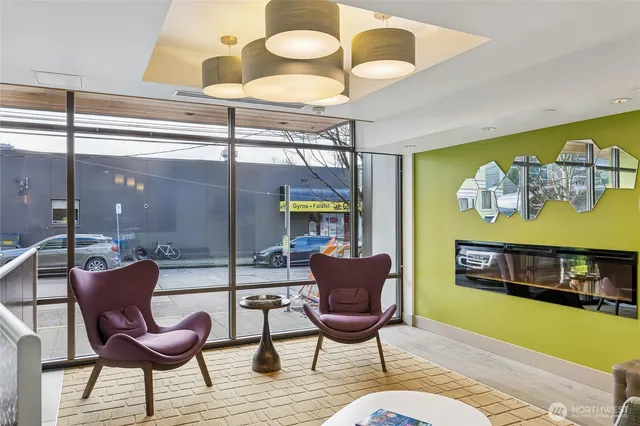 a living room with furniture and painting on the wall