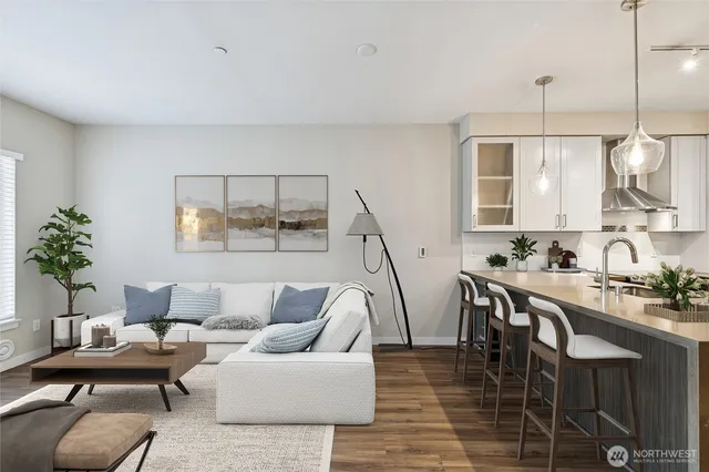 a living room with furniture a chandelier and a dining table