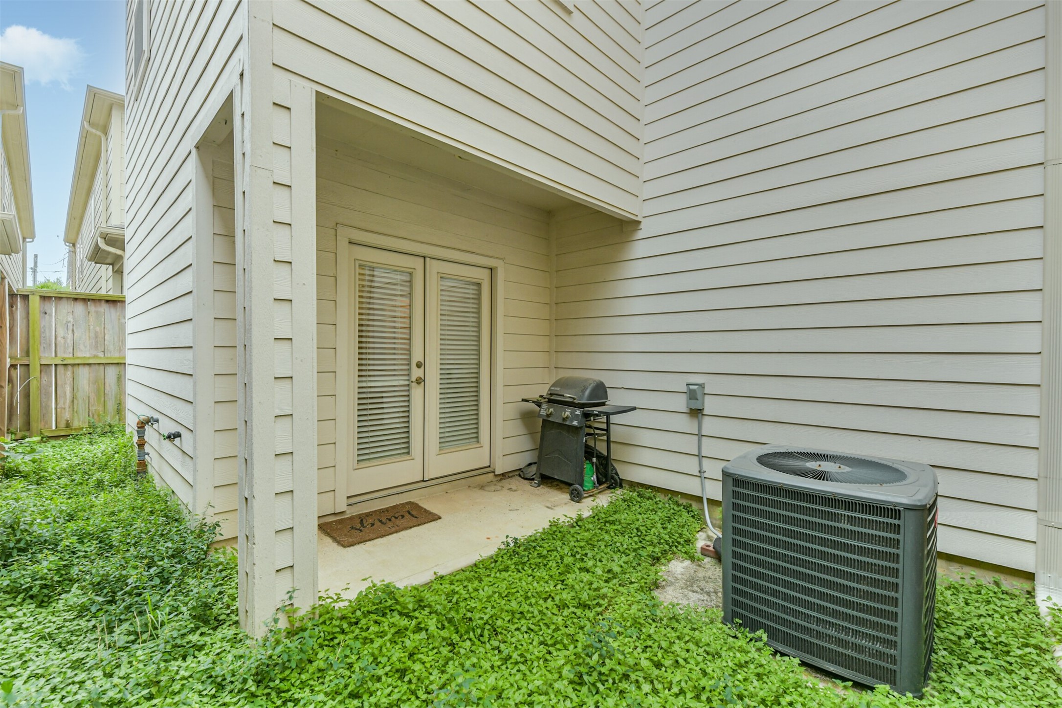 Small patio of the first floor bedroom allows for a space to grill out, or let the pup go, while being very low maintenance.