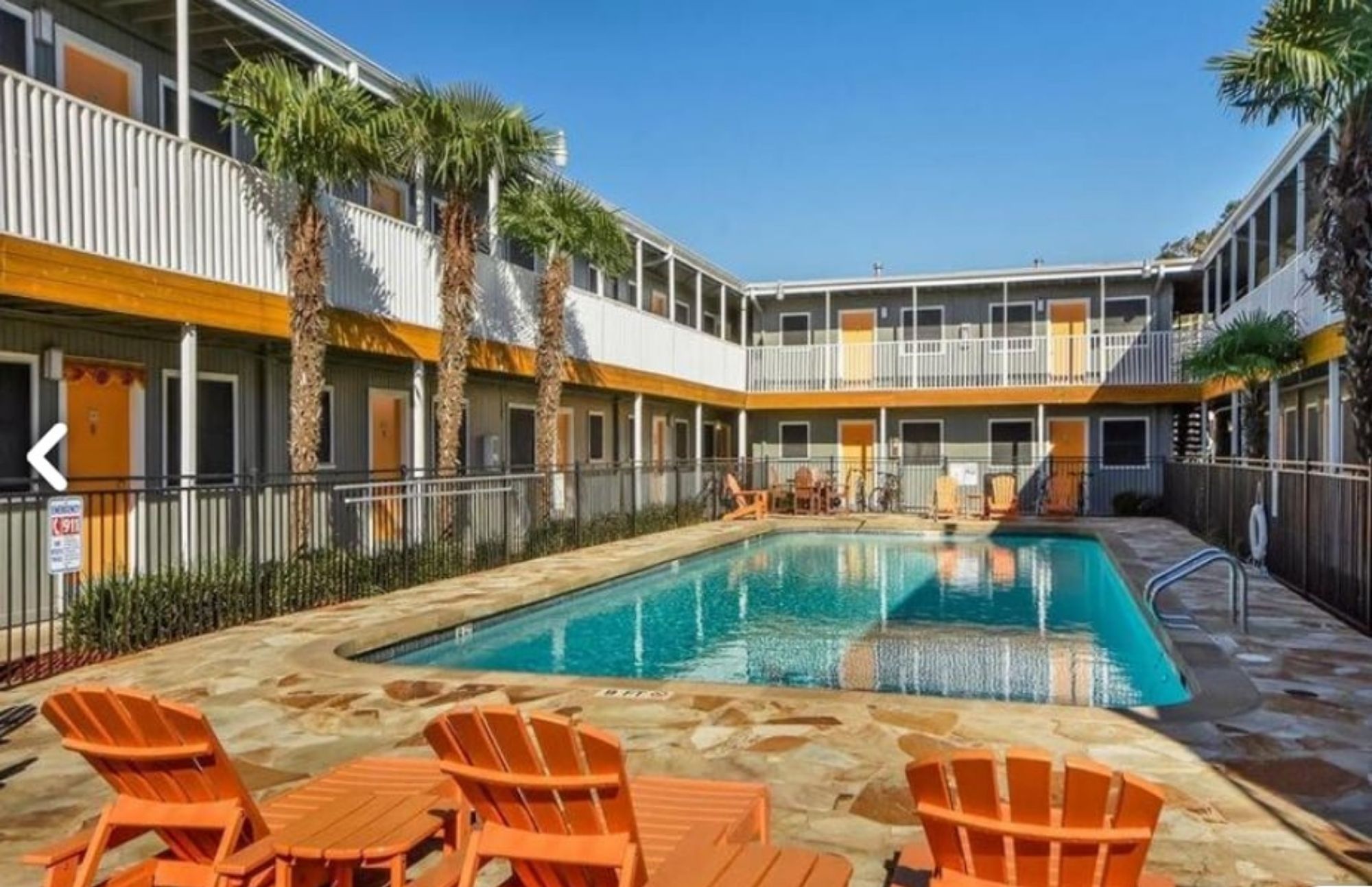 Community pool featuring a patio area and fence