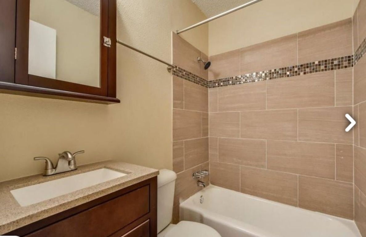 2401 Manor Road, Unit 124 Austin, TX 78722 - Photo 2 of 2 a bathroom with a sink and a mirror