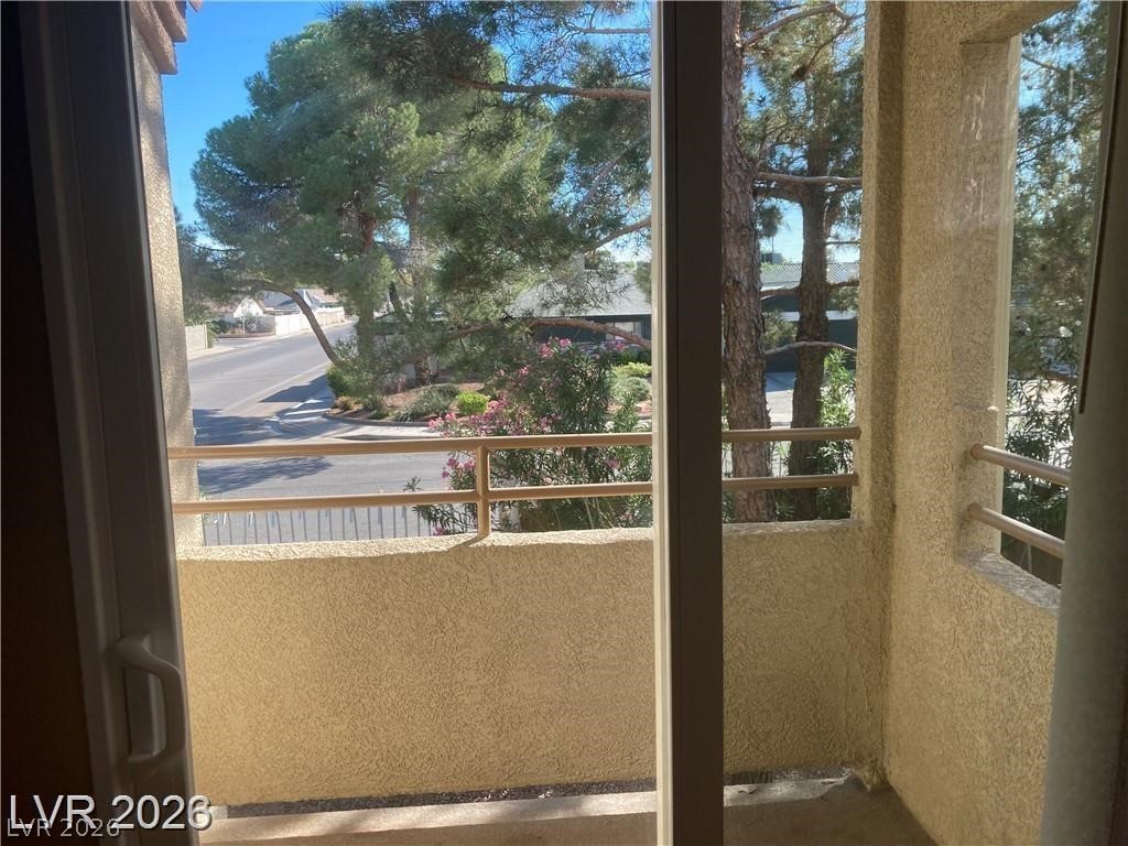 3145 East Flamingo Road, Unit 2100 Las Vegas, NV 89121 - Photo 25 of 34 Step out onto this secluded balcony, offering a serene view of the tree-lined street below.
