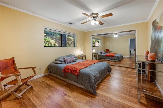 a bedroom with a bed and a large window