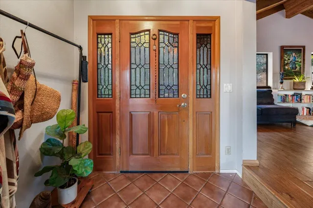 a view of an entryway with wooden floor and a livingroom