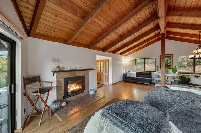 a view of a room with wooden floor and fireplace