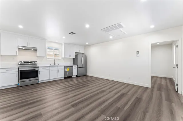 a view of a kitchen with wooden floor