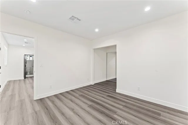 a view of an empty room and wooden floor
