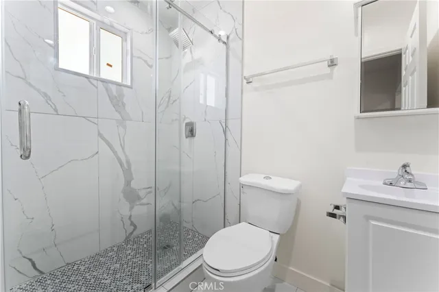 a white toilet sitting next to a bathroom sink