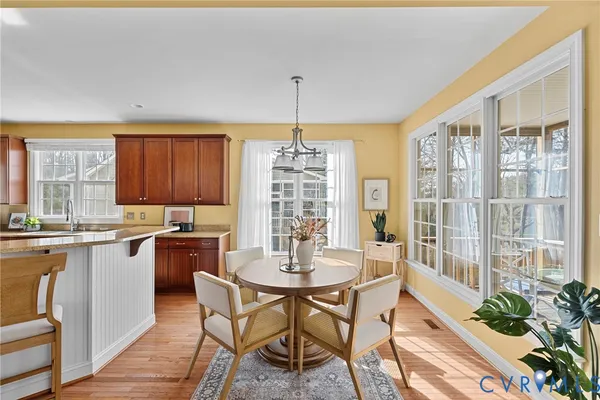 a kitchen with stainless steel appliances granite countertop wooden cabinets a sink and dishwasher with wooden floor