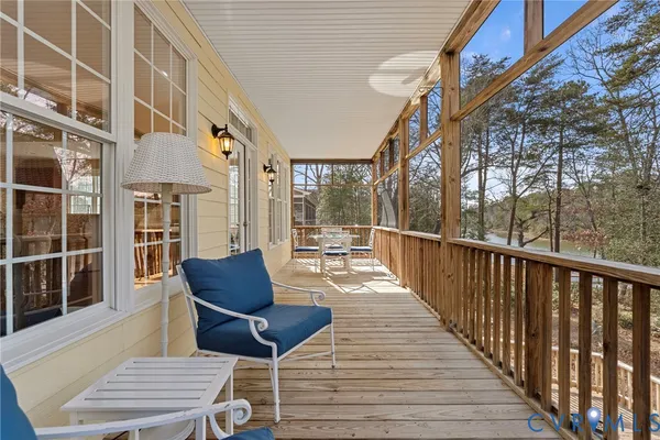 a kitchen with stainless steel appliances granite countertop a stove top oven a sink a dining table and chairs