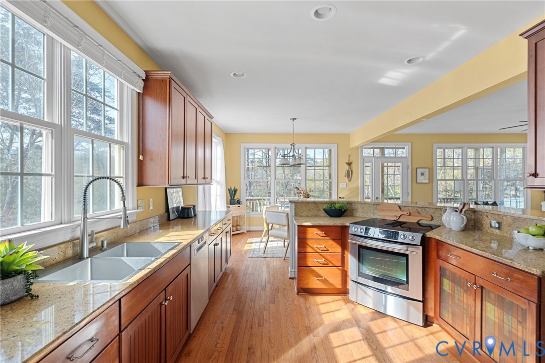 170 Rappa Run Road Topping, VA 23169 - Photo 15 of 60 a kitchen with stainless steel appliances granite countertop a stove top oven a sink a dining table and chairs