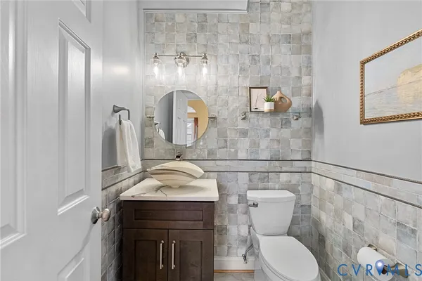 a bathroom with a sink vanity and a mirror