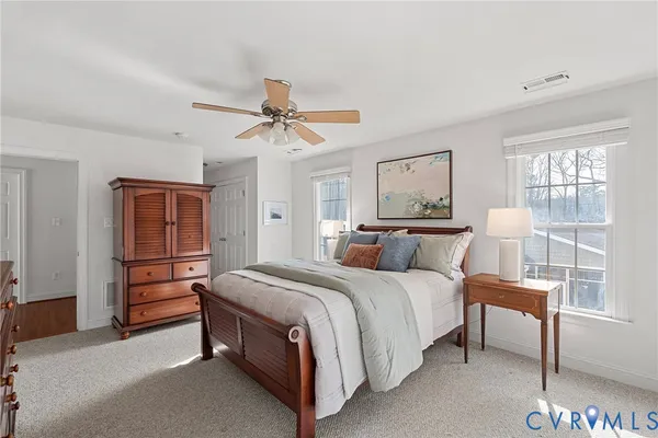a bedroom with a bed a lamp and a chandelier