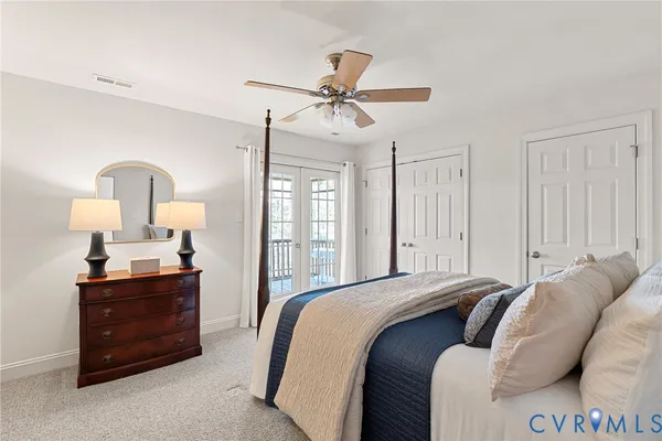 a bedroom with two beds and painting on the wall