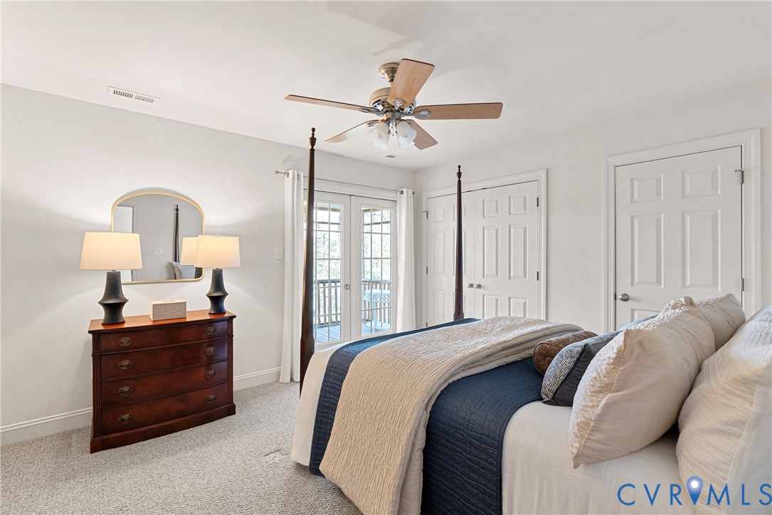 170 Rappa Run Road Topping, VA 23169 - Photo 31 of 60 a bedroom with a bed a lamp and a chandelier