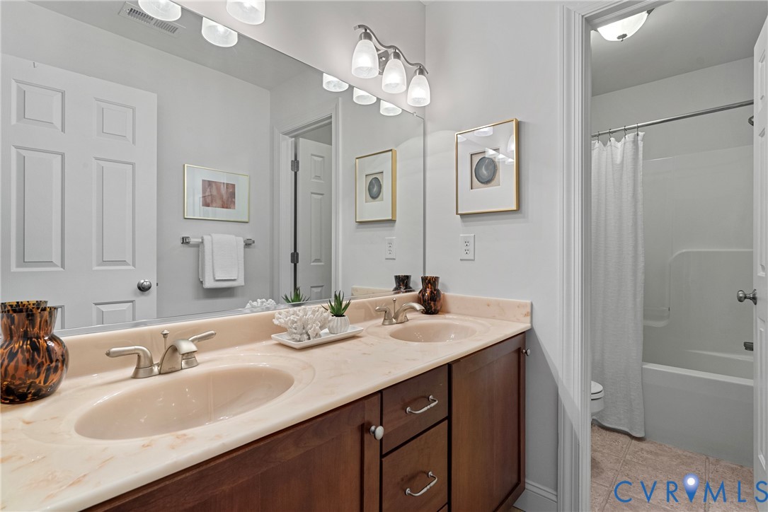 170 Rappa Run Road Topping, VA 23169 - Photo 35 of 60 a bathroom with a sink double vanity granite tub shower and a mirror