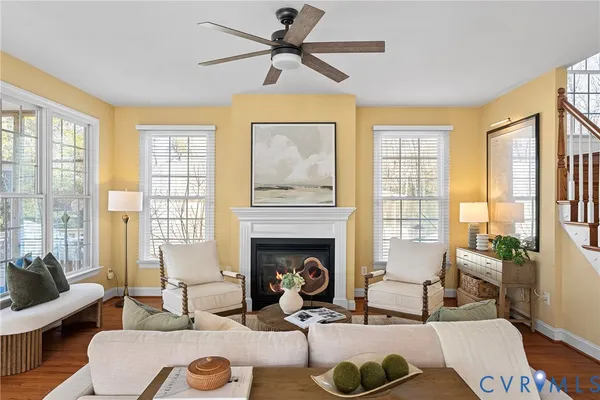 a living room with furniture a rug and kitchen view