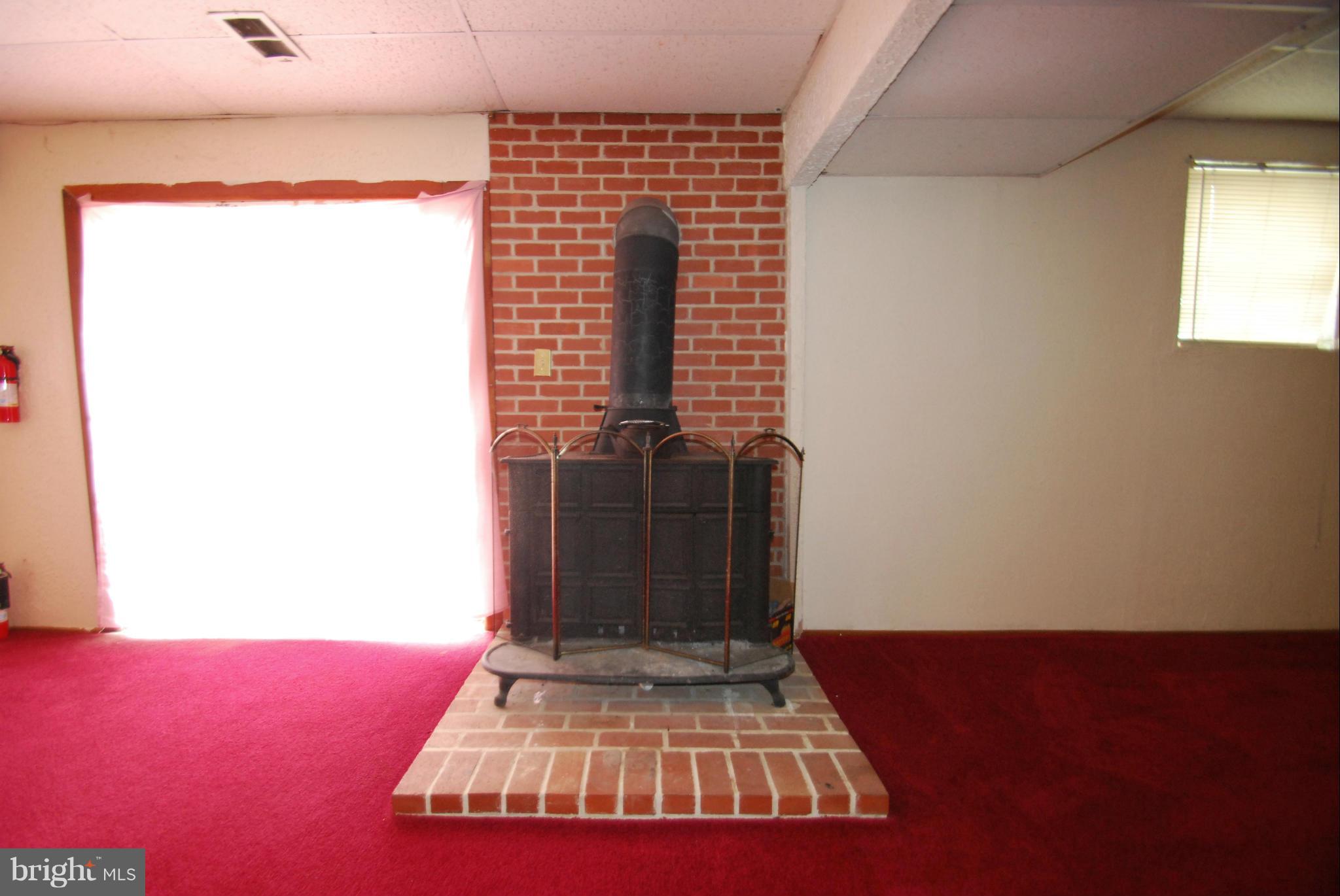 1970 Dominoe Road Annapolis, MD 21401 - Photo 19 of 30 Wood Stove in Finished Lower Level