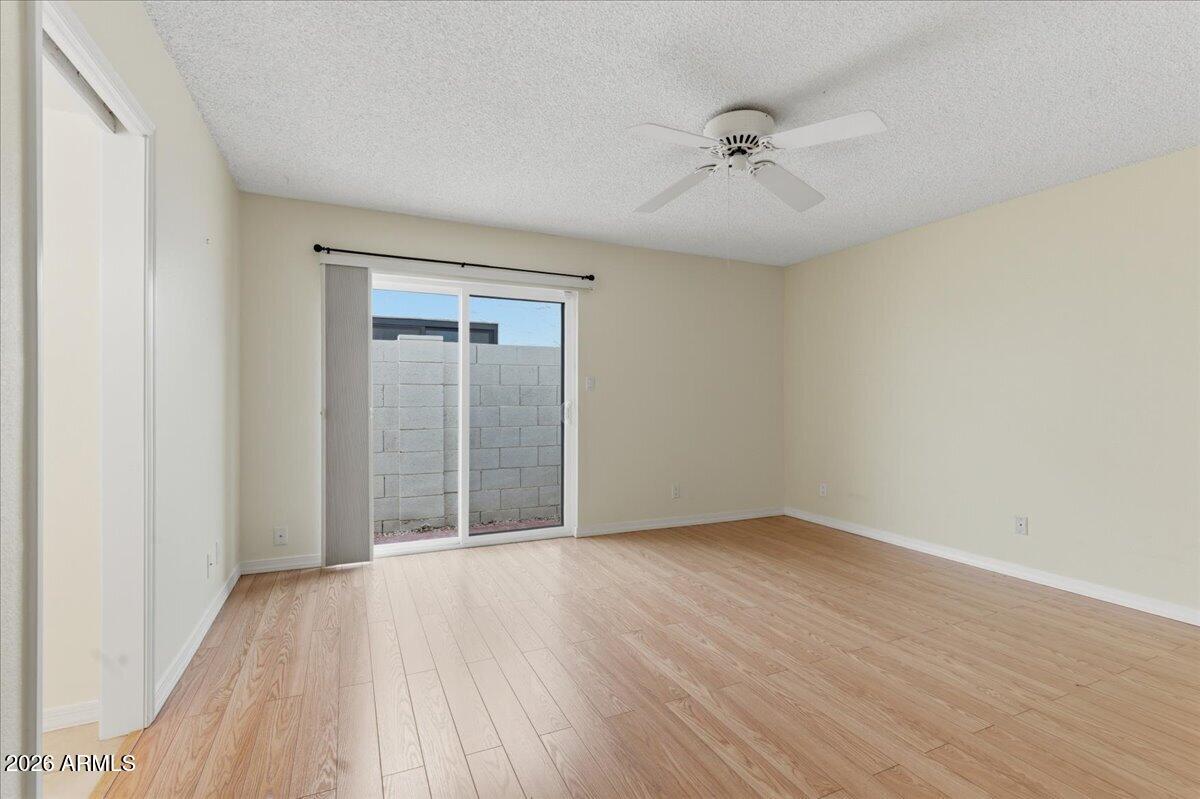 6512 North 12th Way Phoenix, AZ 85014 - Photo 13 of 39 wooden floor in an empty room with a window