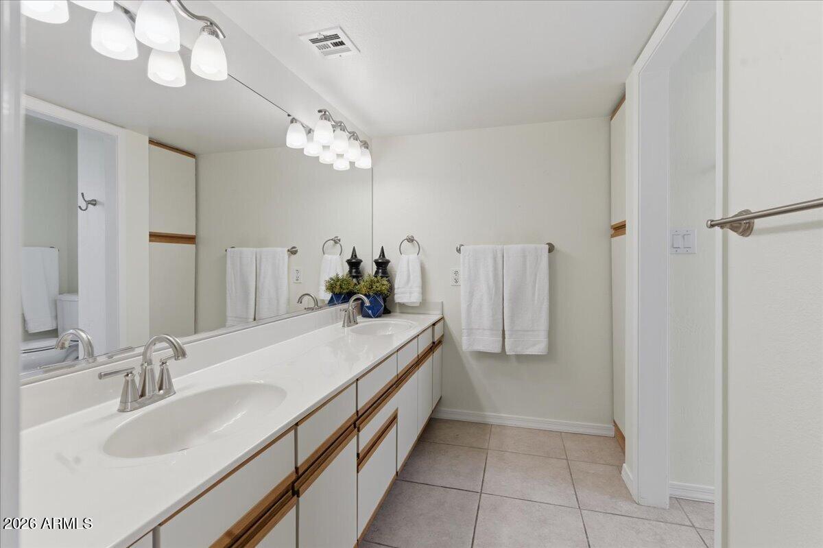 6512 North 12th Way Phoenix, AZ 85014 - Photo 14 of 39 a spacious bathroom with a double vanity sink and a mirror