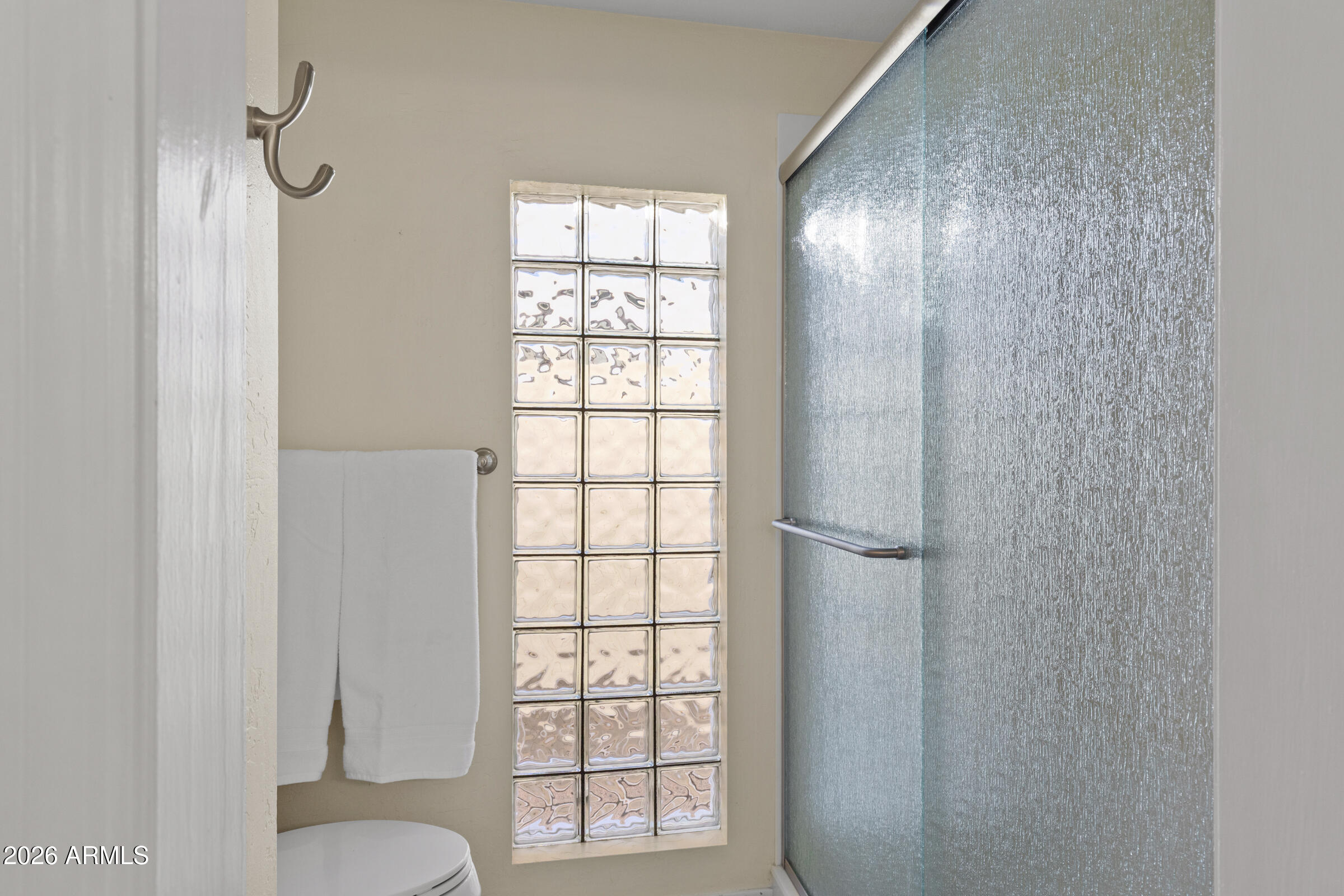 6512 North 12th Way Phoenix, AZ 85014 - Photo 16 of 39 a bathroom with a window and a toilet
