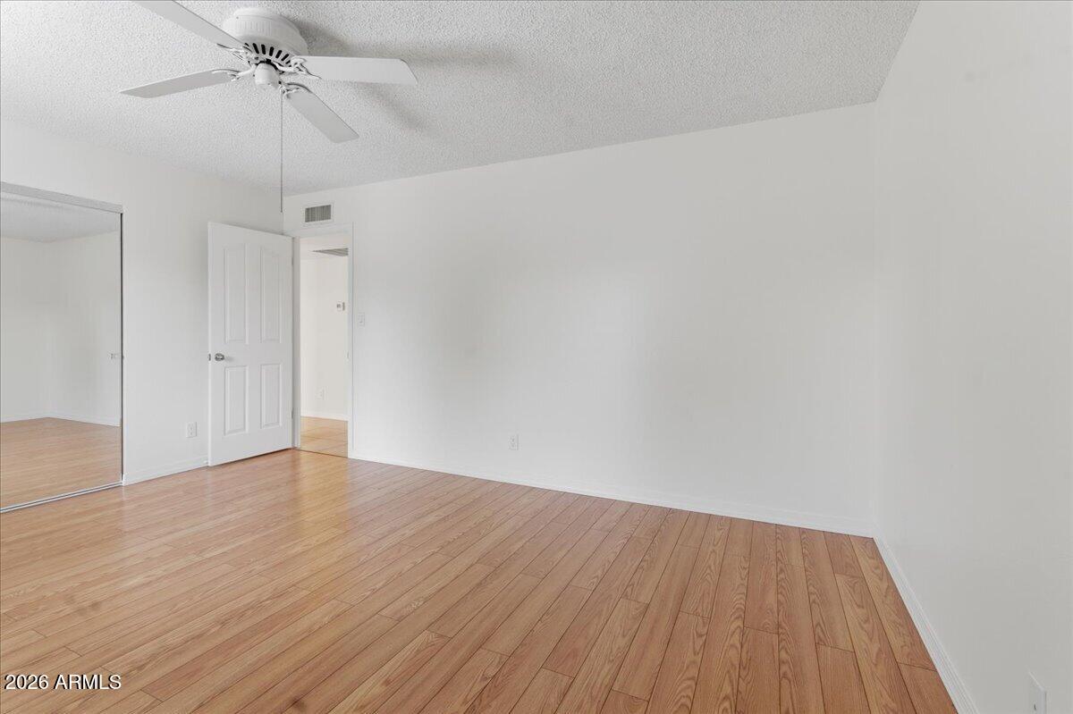 6512 North 12th Way Phoenix, AZ 85014 - Photo 22 of 39 a view of an empty room with wooden floor
