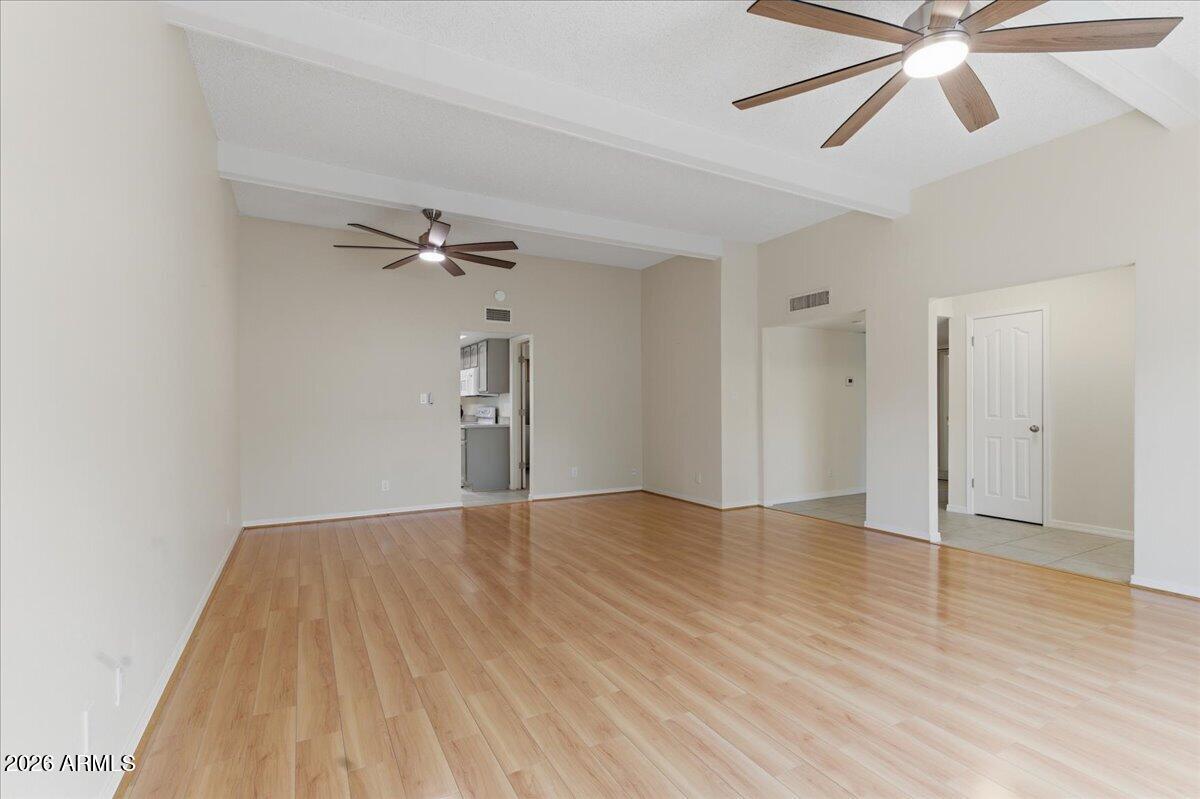 6512 North 12th Way Phoenix, AZ 85014 - Photo 2 of 39 a view of empty room with wooden floor and fan