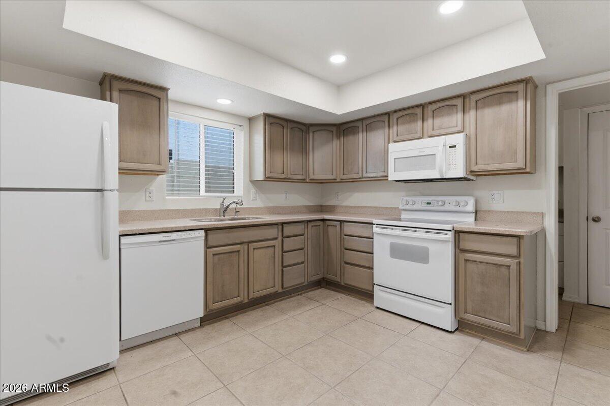 6512 North 12th Way Phoenix, AZ 85014 - Photo 4 of 39 a kitchen with cabinets appliances and a window