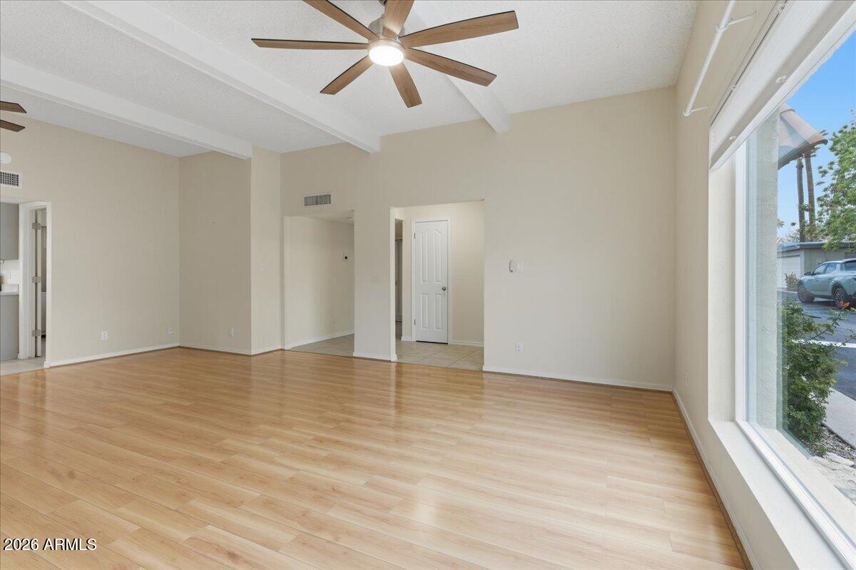 6512 North 12th Way Phoenix, AZ 85014 - Photo 5 of 39 a view of an empty room with wooden floor and a window